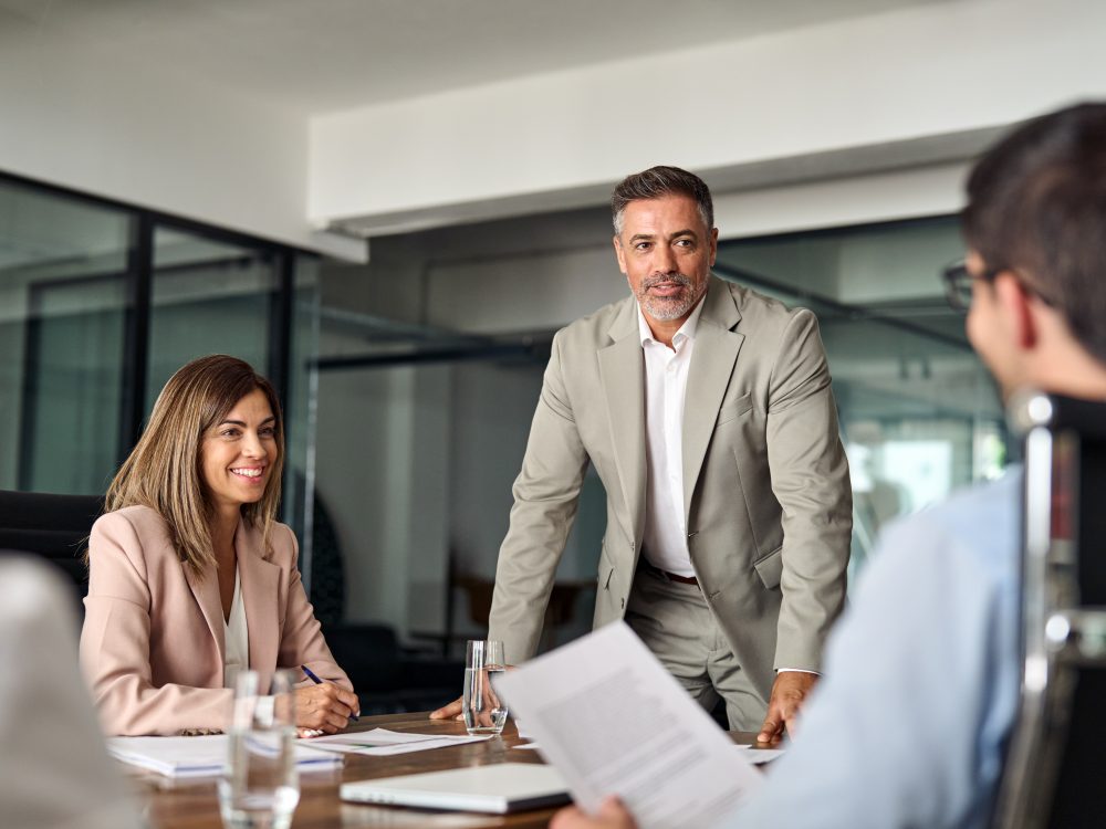 Happy executive manager and team people having discussion at office meeting.