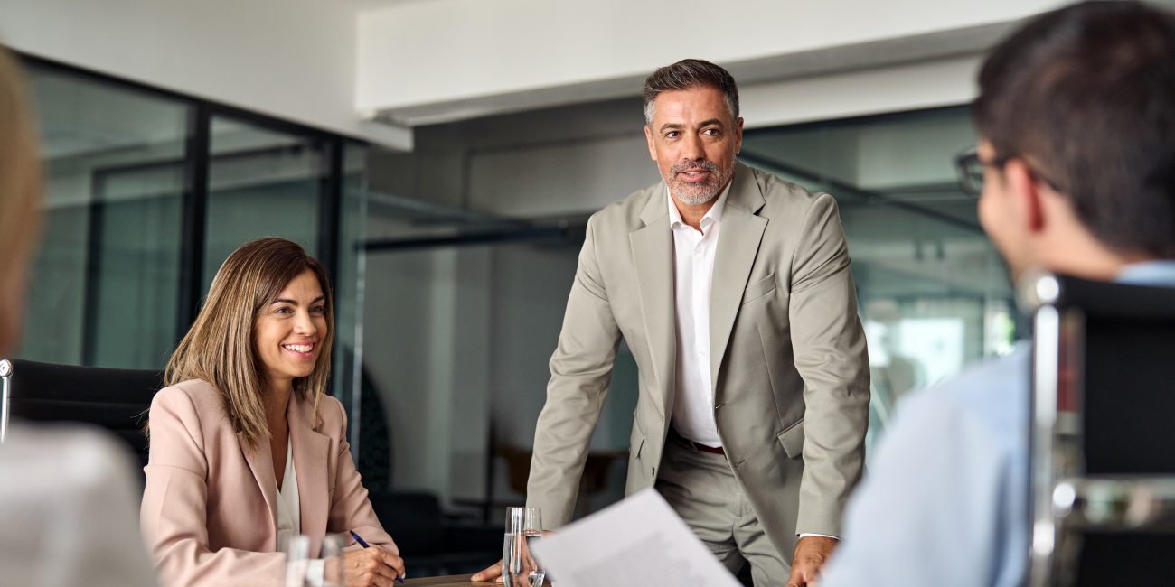 Happy executive manager and team people having discussion at office meeting.